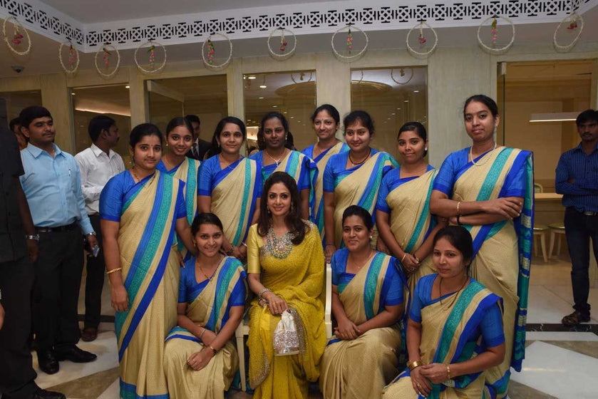 Bollywood Star Sridevi Boney Kapoor with the staff of a premium jewellery showroom donned Uniform Sarees by www.uniformsarees.in Bollywood Star Sridevi Boney Kapoor with the staff of a premium jewellery showroom donned Uniform Sarees by www.uniformsarees.in